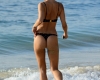 EXCLUSIVE: Kimberley Garner looks sensational in a black bikini as she takes a stroll on the beach in Barbados